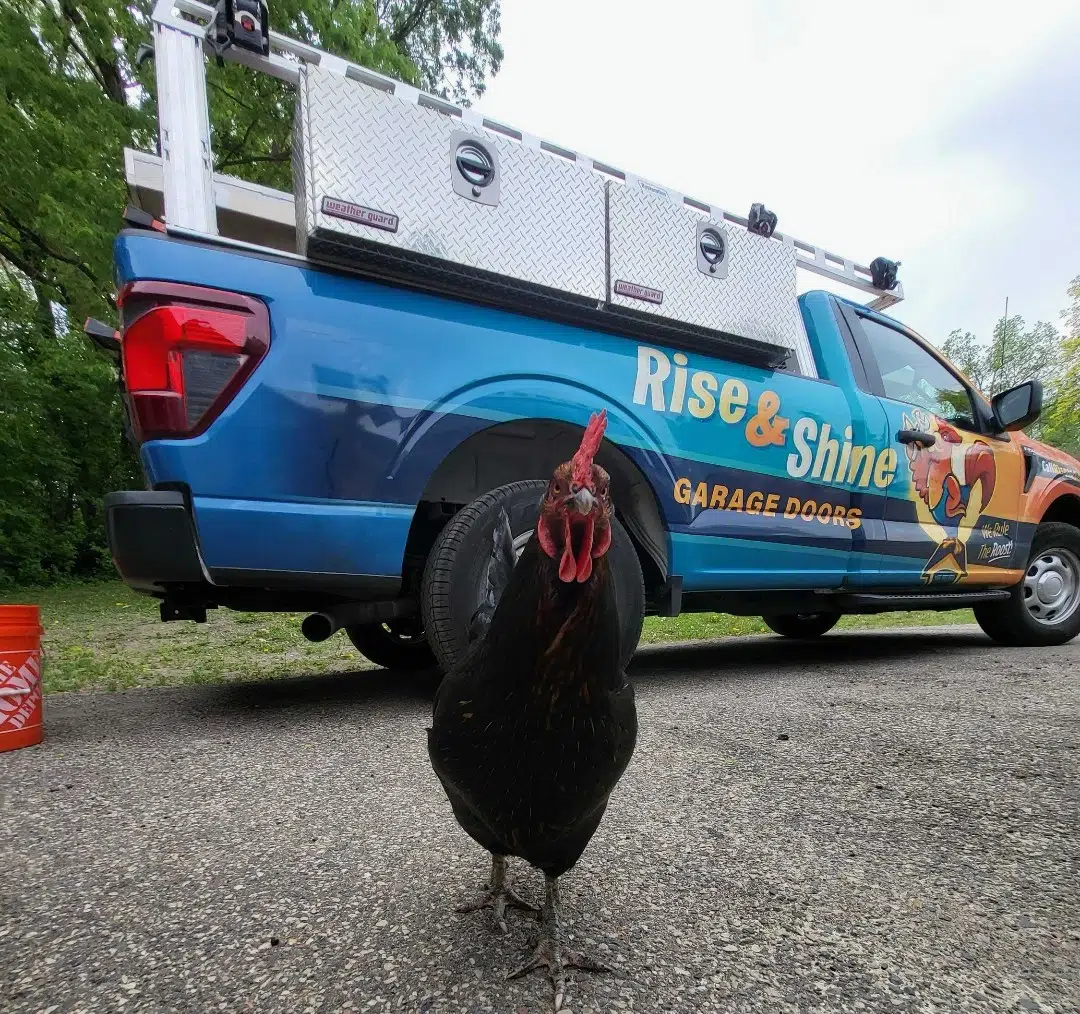 Brown garage door on blue siding house.