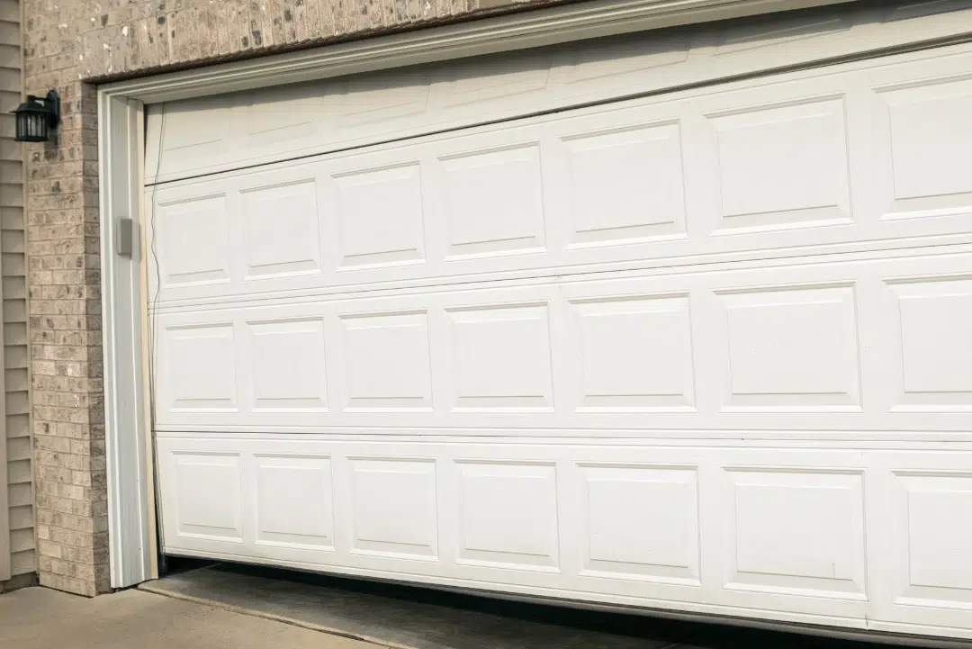 Brown garage door on blue siding house.