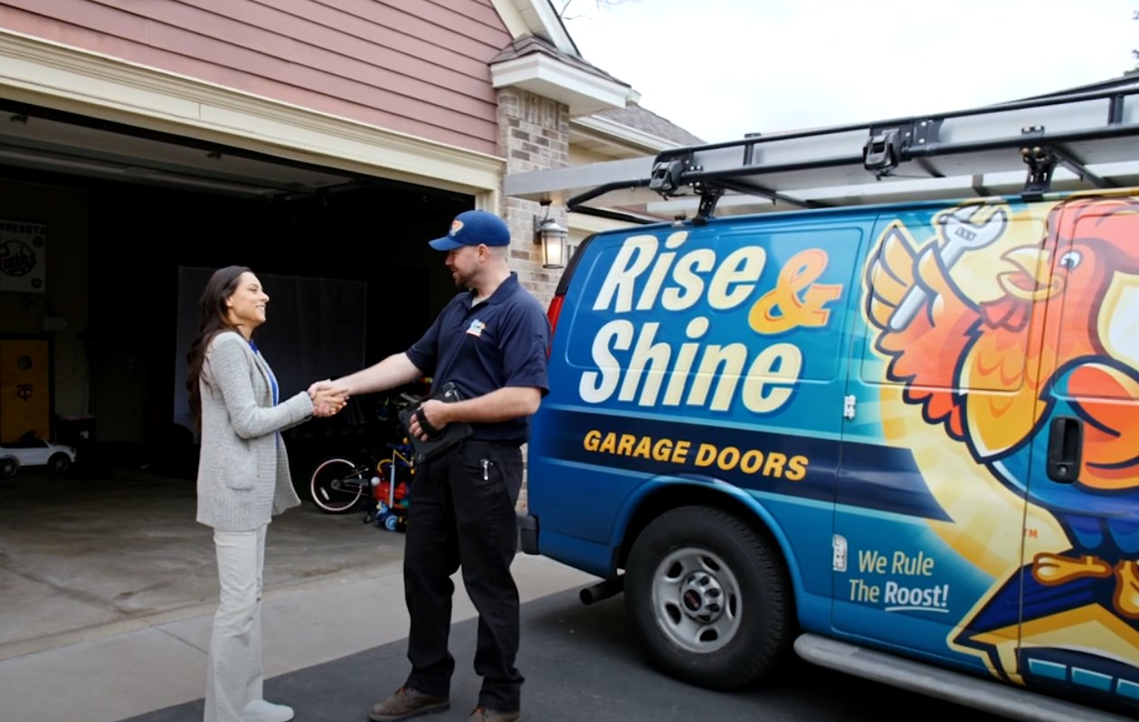 Brown garage door on blue siding house.