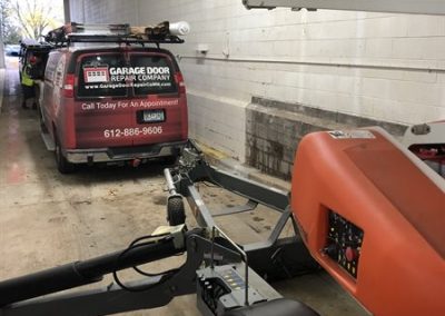 Garage Door Repair Company van in warehouse.